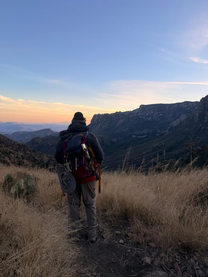 Eduardo Gonzales overlooking a mountain valley at sunset